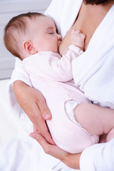 Obraz na płótnie Canvas Newborn baby sucking mother's milk