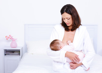 Obraz na płótnie Canvas Mother feeding baby with breast
