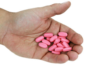 Pills in Hand on White Background