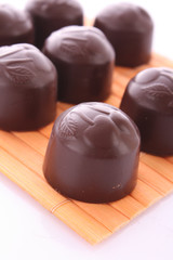 Chocolates on wooden surface isolated