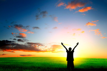 happy person in the field on the sunset background