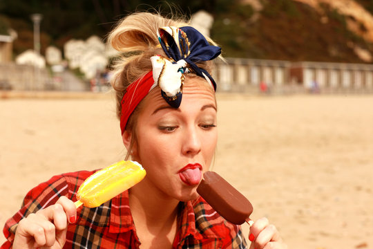 Young Woman Eating Two Ice Lolly. Model Released