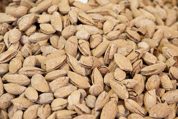 Big pile of raw almonds in shells
