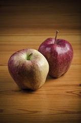 Two apples on wooden desk