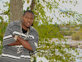 Young African American man with his arms crossed.