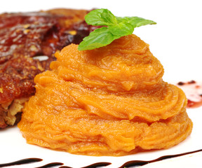 Orange sweet potato puree with a mint leaf on top
