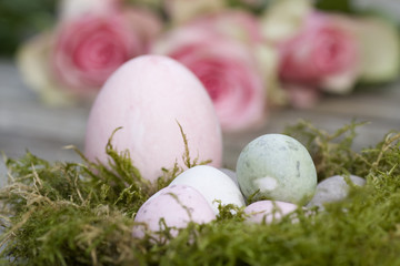 Naklejka na ściany i meble Easter eggs in pastel in the nest with roses