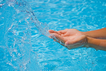 Female hands and water splashes