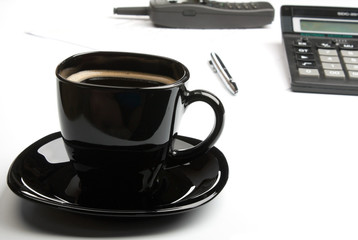 coffee mug, calculator, pens, phone