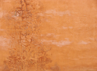 orange colored grunge wall with stains and marks