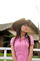 cowgirl waiting infront of country wooden house