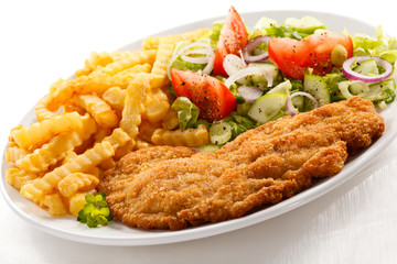 Pork chop, French fries and vegetables