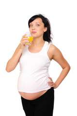 Young pregnant woman drinking orange