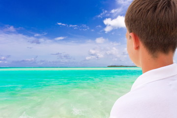 Boy looking at tropical sea