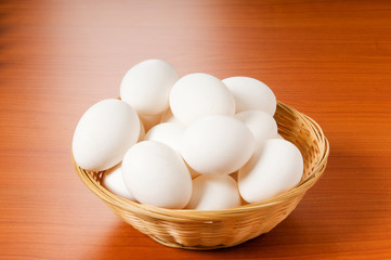 Many white eggs on the wooden table