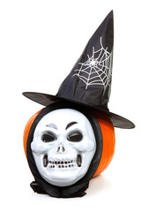 pumpkin with witch hat and mask over white background