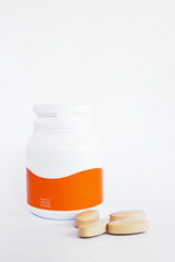 vitamin c bottle and medicine tablets isolated