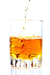 Whisky,rum or any other golden liquor being poured into a glass