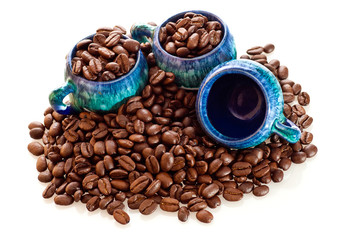 Coffee beans and cups on a white background