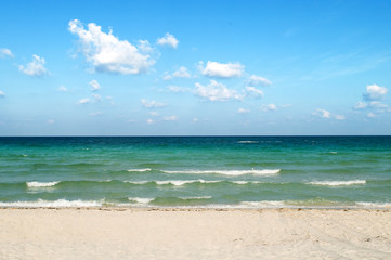 Fototapeta na wymiar Sand beach on the bright summer day
