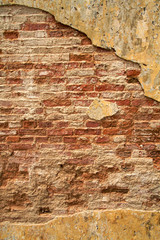 Textured cracked urban brick wall