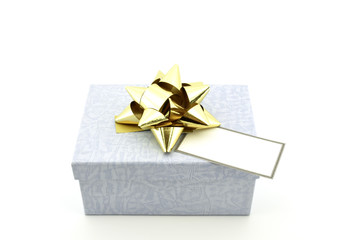 blue box with gold bow and blank tag isolated on white