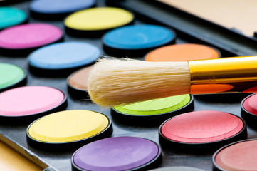 Art concept with painters palette and paint brush