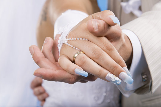 Hands of groom and bride.