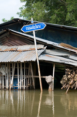 Road sign in flooded village in Thailand