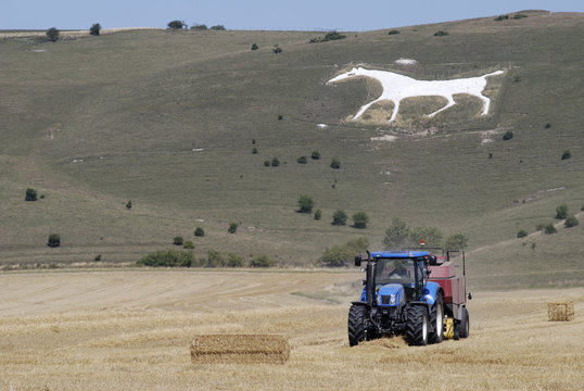 Tractor under White Chalk Horse. Wiltshire. England