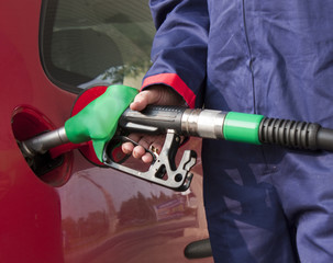 Gas Station Worker Refilling Car at Service Station