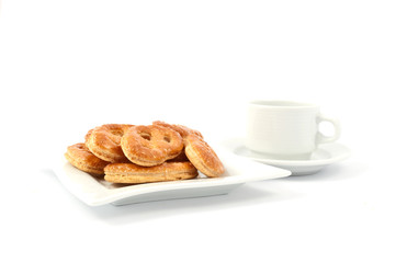 pretzels on a plate with a cup of coffee