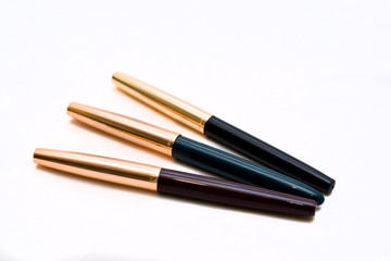 Three ink pens on a white background