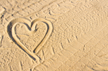Heart sign drawn on sand