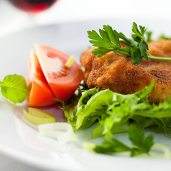 Closeup of schnitzel with fresh vegetables