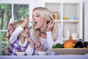 woman and girl with yogurt bowl