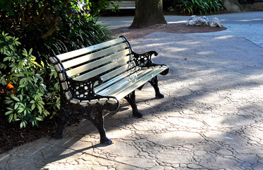 Metal bench painted beige in a park