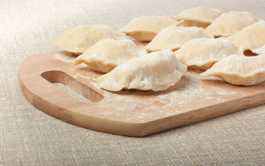 Fototapeta na wymiar Raw dumplings on cutting board