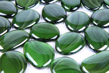 Green decorative stones on white background