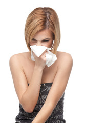 young woman blowing her nose