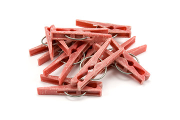 pile of plastic clothes pegs on white background