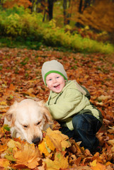Boy in autumn leaves