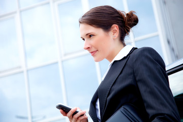 young business woman outside with mobile phone