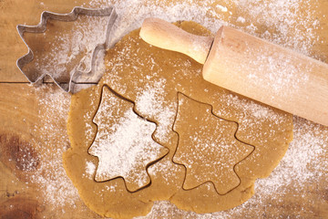 christmas gingerbread tree cookies with cutter , dough and rolli