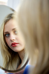 Fototapeta premium Teenage Girl Looking In Mirror. Model Released