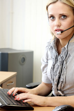 Young Business Woman Working with Headphones. Model Released