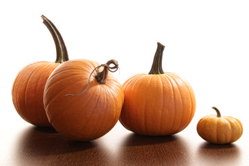 Colorful festive pumpkins  on wood table against white