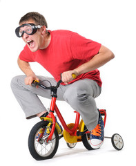 The curious man in goggles on a children's bicycle