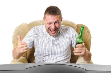 The man with beer in an armchair watches TV isolated