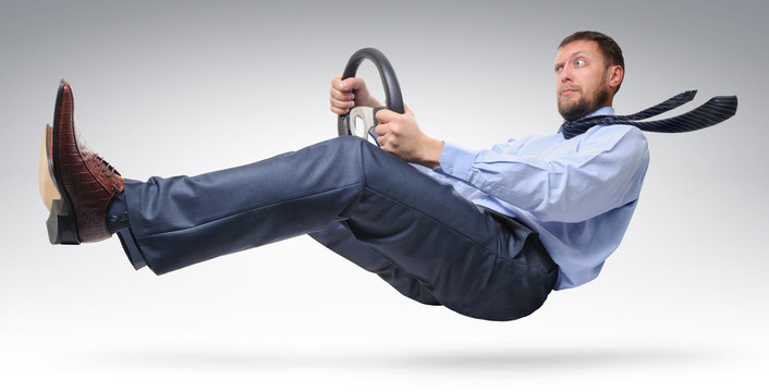 Businessman driver in a tie with a wheel